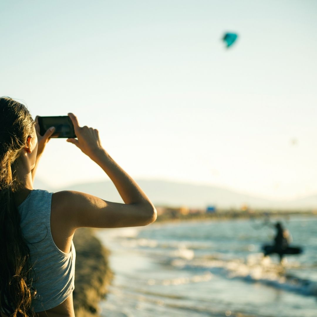 Girl with binoculars looking out at the ocean